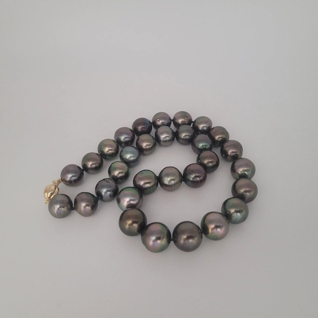 Dark Tahitian pearl luster close-up 12-13mm — black-green natural color