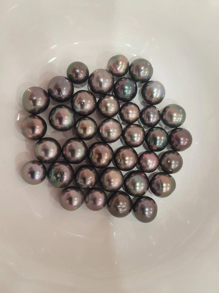Aubergine Tahitian cultured pearl 10-11mm luster close-up — natural color